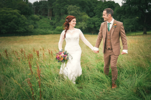 Wedding couple walking through the Hay meadows